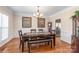 Formal dining room featuring wainscoting, hardwood floors, and an elegant chandelier at 5608 Old Town Ln, Gastonia, NC 28056