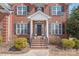 Charming brick home featuring a welcoming front entrance with manicured landscaping at 5608 Old Town Ln, Gastonia, NC 28056