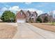 Beautiful two-story brick home featuring a large driveway, well-manicured lawn, and mature trees in a desirable neighborhood at 5608 Old Town Ln, Gastonia, NC 28056