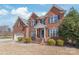 Beautiful brick home featuring an inviting entrance with manicured landscaping, creating a warm and welcoming curb appeal at 5608 Old Town Ln, Gastonia, NC 28056
