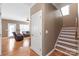 Hallway view with stairs and entrance to a living room with leather seating at 5608 Old Town Ln, Gastonia, NC 28056