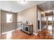 Hallway featuring hardwood floors, decorative railing, and a stylish console table at 5608 Old Town Ln, Gastonia, NC 28056