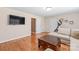 Spacious living room featuring hardwood floors, large TV, and ample seating at 5608 Old Town Ln, Gastonia, NC 28056