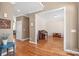 Open-concept living room featuring hardwood floors and a cozy seating area with an upright piano at 5608 Old Town Ln, Gastonia, NC 28056