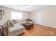Inviting living room with hardwood floors, comfortable sectional sofa, and natural light at 5608 Old Town Ln, Gastonia, NC 28056