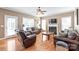 Inviting living room boasts hardwood floors, a cozy fireplace, and comfortable leather seating at 5608 Old Town Ln, Gastonia, NC 28056