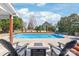Beautiful backyard pool area with seating and lush landscaping, ideal for relaxation at 5608 Old Town Ln, Gastonia, NC 28056