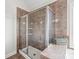 Tiled shower featuring a glass door and built-in shelving for toiletries at 5608 Old Town Ln, Gastonia, NC 28056