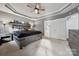 This primary bedroom features gray walls, a ceiling fan, and an ensuite bathroom at 6614 Redbridge Trl, Charlotte, NC 28269