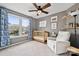 Gray Bedroom features large windows, blue curtains, and a comfortable white recliner at 6614 Redbridge Trl, Charlotte, NC 28269