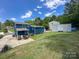 Backyard view featuring the home's exterior, driveway, and grassy lawn at 7812 Highbanks Ct, Charlotte, NC 28212