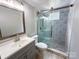 Bathroom with updated vanity and a glass door shower with tile accents at 7812 Highbanks Ct, Charlotte, NC 28212