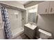 Bathroom featuring updated vanity, lighting, and tiled walk-in shower at 7812 Highbanks Ct, Charlotte, NC 28212