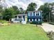 Charming two-story home with a well-manicured lawn, inviting front porch, and a bright yellow front door at 7812 Highbanks Ct, Charlotte, NC 28212