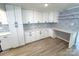 Bright kitchen featuring white cabinets, quartz countertops, stainless steel appliances, and a stylish backsplash at 7812 Highbanks Ct, Charlotte, NC 28212