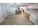 Spacious kitchen features an open layout, stainless steel appliances, quartz countertops, and hardwood floors at 7812 Highbanks Ct, Charlotte, NC 28212
