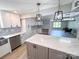 Modern kitchen featuring stainless steel appliances, stylish backsplash, quartz countertops, and hardwood floors at 7812 Highbanks Ct, Charlotte, NC 28212