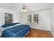 Serene bedroom with hardwood floors, a ceiling fan, and abundant natural light from the windows at 810 Ashwood St, Kannapolis, NC 28081
