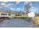 Wide gravel driveway leading to a carport and detached garage, with a full fenced yard at 810 Ashwood St, Kannapolis, NC 28081
