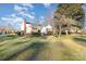 Well-maintained home with a spacious front yard and mature trees, perfect for outdoor activities at 810 Ashwood St, Kannapolis, NC 28081