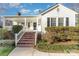 Charming home featuring a covered front porch, brick steps, and fresh landscaping for curb appeal at 810 Ashwood St, Kannapolis, NC 28081
