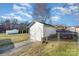 Detached garage with white siding and a fenced-in yard and gravel driveway at 810 Ashwood St, Kannapolis, NC 28081