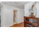 Hallway view of a bathroom with a wooden cabinet on a hardwood floor at 810 Ashwood St, Kannapolis, NC 28081