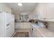 Charming white kitchen featuring standard appliances and access to the dining room at 810 Ashwood St, Kannapolis, NC 28081