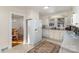 Classic white kitchen featuring standard appliances, ample cabinet space, and a view into the dining room at 810 Ashwood St, Kannapolis, NC 28081