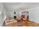 Inviting living room boasts hardwood floors, fireplace, and seamless flow to the dining area at 810 Ashwood St, Kannapolis, NC 28081