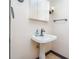Bathroom featuring a pedestal sink with modern faucet, vanity light, and mirror at 8909 Abberley Ct, Huntersville, NC 28078