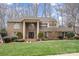 Beautiful two-story brick home with a well-manicured lawn, mature landscaping, and a welcoming front entrance at 8909 Abberley Ct, Huntersville, NC 28078