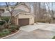 Attached garage with driveway and mature trees at 8909 Abberley Ct, Huntersville, NC 28078