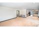 Spacious living room with neutral walls, carpet flooring, and kitchen access at 8909 Abberley Ct, Huntersville, NC 28078