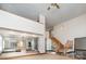 Expansive living room with a wooden staircase, chandelier, and large windows at 8909 Abberley Ct, Huntersville, NC 28078