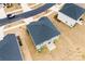 An aerial view of a home featuring a backyard with a new patio and green lawn, complemented by a sleek roof at 916 Clementine Rd, Monroe, NC 28110