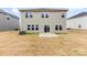 Large backyard features a patio, green grass, with modern home exterior including a sliding glass door at 916 Clementine Rd, Monroe, NC 28110