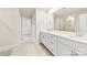 Elegant bathroom featuring double sinks, modern fixtures, and a glass-enclosed shower at 916 Clementine Rd, Monroe, NC 28110