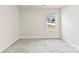 Bedroom features neutral walls, carpet, a window overlooking the yard, and natural light at 916 Clementine Rd, Monroe, NC 28110