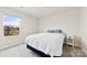 Bright bedroom with soft carpet, a window overlooking the neighborhood, and a comfortable bed at 916 Clementine Rd, Monroe, NC 28110