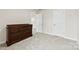 Bedroom featuring neutral carpet and paint, an open door, and a dark brown dresser at 916 Clementine Rd, Monroe, NC 28110