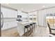 A modern kitchen with white cabinets, stainless steel appliances, and a large granite island at 916 Clementine Rd, Monroe, NC 28110