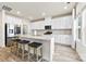 A modern kitchen with white cabinets, stainless steel appliances, and a large granite island with seating at 916 Clementine Rd, Monroe, NC 28110