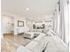 Open-concept living area with a large sectional couch, hardwood floors, and seamless flow into the modern kitchen at 916 Clementine Rd, Monroe, NC 28110
