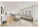 Spacious living area featuring hardwood floors, a large sectional couch, and an open floor plan to the kitchen at 916 Clementine Rd, Monroe, NC 28110