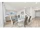 A spacious living area with a glass table, lots of windows, and a comfortable couch at 916 Clementine Rd, Monroe, NC 28110