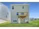 View of backyard with a wooden deck on a two-story house with green siding at 10115 Chatham Run Ln, Charlotte, NC 28262