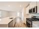 Modern kitchen with stainless steel appliances, island with sink, and white cabinets at 10115 Chatham Run Ln, Charlotte, NC 28262