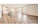 Bright, open-concept living space with hardwood floors and sliding doors to patio at 10115 Chatham Run Ln, Charlotte, NC 28262
