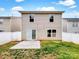 Backyard with a concrete patio, fenced in lawn, and exterior sliding door at 10312 Hugue Way, Charlotte, NC 28214